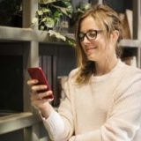 women checking text financing