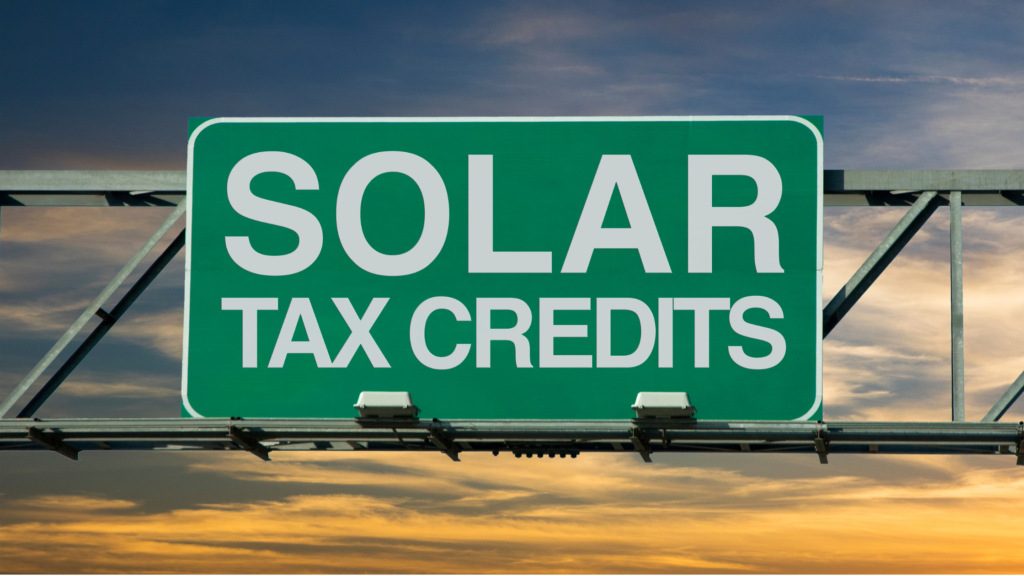 A green sign that displays solar tax credits.