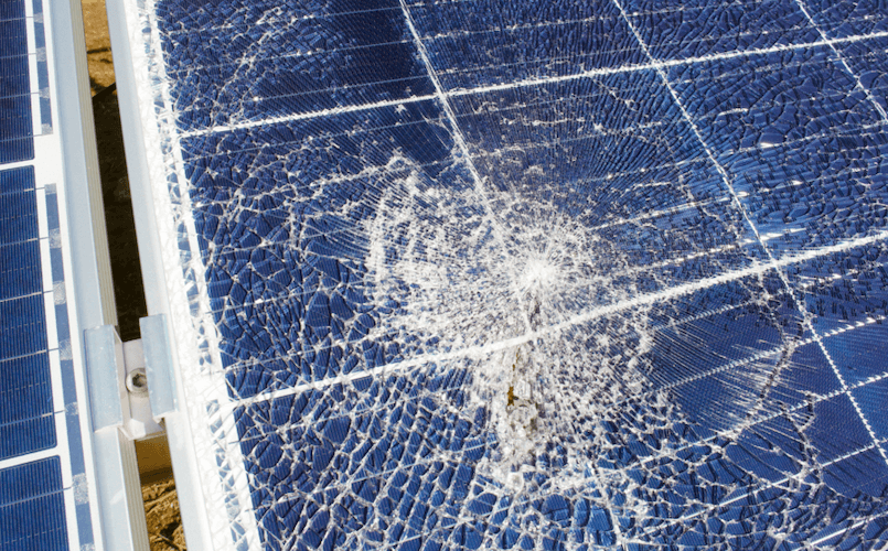 A broken solar panel on a sunny day.
