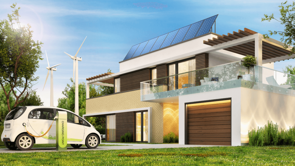 An electric car parked in front of a house with wind turbines.