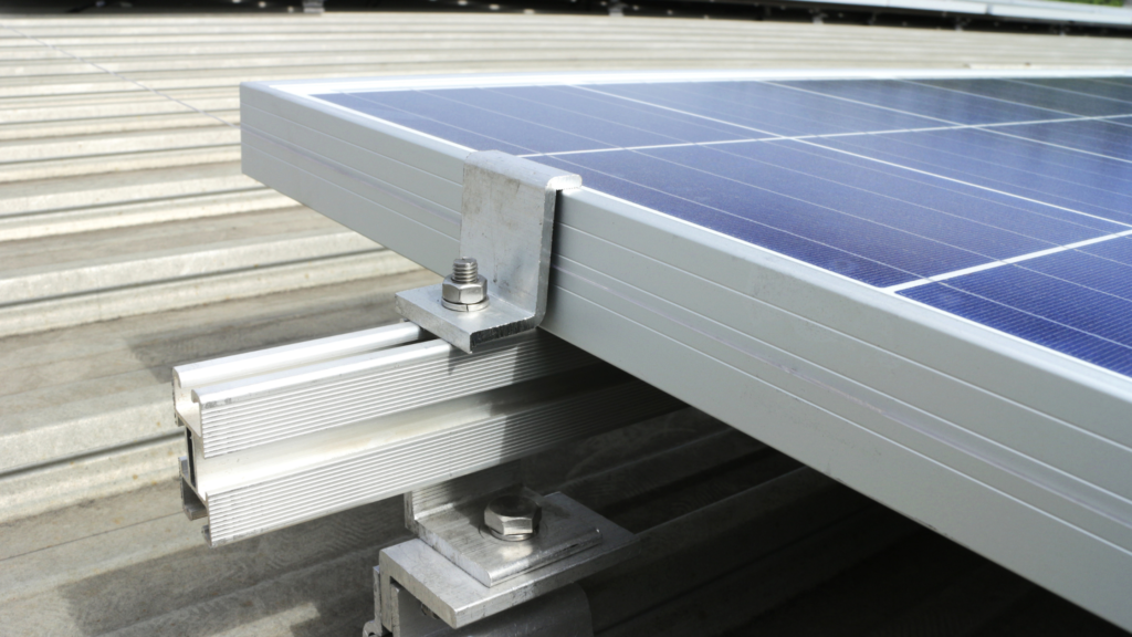 Close-up of a solar panel mounted on a metal structure, showing details of the mounting hardware and bolts securing it in place. Perfect for those considering Solar Panel Kits in 2024.